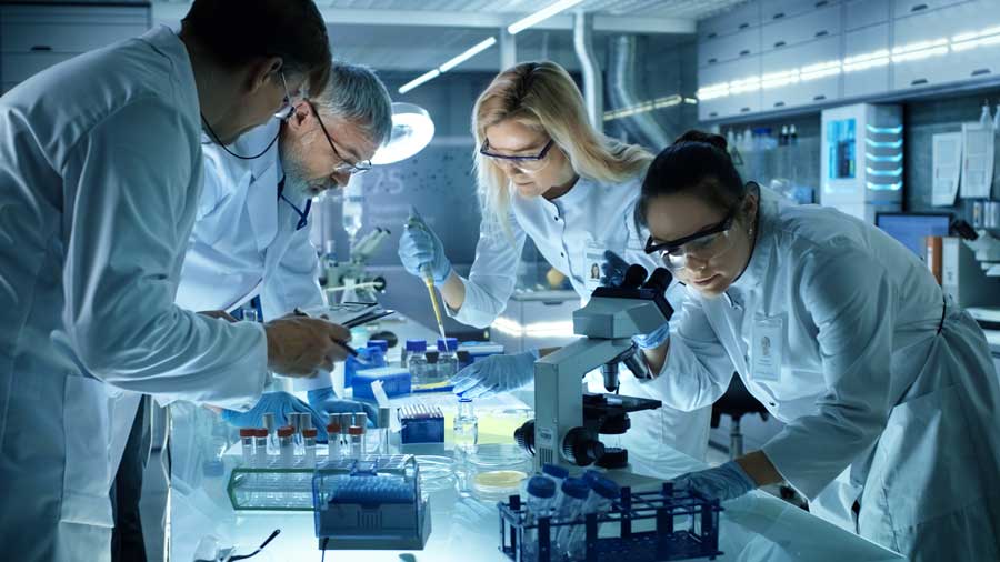 group of scientists analyzing samples in a lab